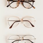Stylish diverse glasses arranged in row lying down glasses on beige table